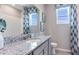 Well-lit bathroom featuring a granite countertop and modern fixtures with window at 805 157Th E Ct, Bradenton, FL 34212