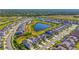 Aerial view of a residential community with homes and a large pond with lush greenery surrounding the area at 8612 Evening Dr, Sarasota, FL 34241
