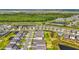 Beautiful aerial view of homes with landscaping and a pond with a backdrop of lush green trees at 8612 Evening Dr, Sarasota, FL 34241
