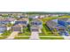 Aerial view of homes in a well-maintained neighborhood with pond at 8612 Evening Dr, Sarasota, FL 34241