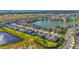 An aerial view of a large community with multiple homes surrounding a large pond at 8612 Evening Dr, Sarasota, FL 34241