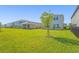 Home backyard with expansive lawn and privacy fence at 8612 Evening Dr, Sarasota, FL 34241