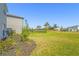 Spacious backyard lawn, complimented by native foliage, offering a serene retreat at 8612 Evening Dr, Sarasota, FL 34241
