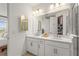 Stylish bathroom with double sink vanity, large mirror, and modern fixtures at 8612 Evening Dr, Sarasota, FL 34241