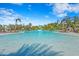 Expansive community pool surrounded by palm trees, lounge chairs, and private cabanas for relaxation at 8612 Evening Dr, Sarasota, FL 34241