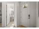 Bright entryway leading to powder room with open door to the laundry room at 8612 Evening Dr, Sarasota, FL 34241