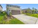 Two-story home with a long driveway, two car garage, and professionally landscaped front yard at 8612 Evening Dr, Sarasota, FL 34241