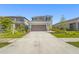 Charming two-story home featuring a well-manicured lawn, neutral paint, and a spacious two-car garage at 8612 Evening Dr, Sarasota, FL 34241