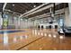 Large indoor gymnasium with basketball hoops, natural light, and gleaming hardwood floors at 8612 Evening Dr, Sarasota, FL 34241