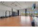 Spacious gym with hardwood floors, mirrors, and various fitness equipment, providing ample workout space at 8612 Evening Dr, Sarasota, FL 34241