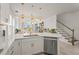 Modern kitchen featuring white cabinetry, quartz countertops, stainless steel appliances, and open sightlines at 8612 Evening Dr, Sarasota, FL 34241