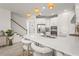 Modern kitchen features a spacious island with seating, stainless appliances, and stylish pendant lighting at 8612 Evening Dr, Sarasota, FL 34241