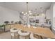 Open concept kitchen flows seamlessly into the dining area, featuring modern lighting and ample seating at 8612 Evening Dr, Sarasota, FL 34241