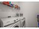 Laundry room with white washer, dryer, and shelving for storage at 8612 Evening Dr, Sarasota, FL 34241