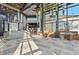 A modern lobby with high ceilings, tiled floors, sofas, and hanging plants creates an inviting space at 8612 Evening Dr, Sarasota, FL 34241