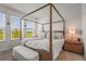 Comfortable main bedroom featuring a four-poster bed and a tranquil view at 8612 Evening Dr, Sarasota, FL 34241
