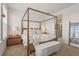 Inviting primary bedroom with four-poster bed frame, walk-in closet, and ensuite bathroom at 8612 Evening Dr, Sarasota, FL 34241