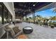 Inviting outdoor lounge with stylish wicker furniture, ceiling fans, and beautiful views of the pool area at 8612 Evening Dr, Sarasota, FL 34241