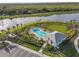 Aerial view of a community pool with surrounding landscaping and a pool house at 8612 Evening Dr, Sarasota, FL 34241