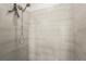 Modern shower with sleek gray tile and contemporary showerhead at 8612 Evening Dr, Sarasota, FL 34241