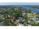 Stunning aerial view of home's location near the water, highlighting mature trees and the surrounding neighborhood at 1010 Tropical Dr, Bradenton, FL 34208