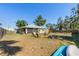 Expansive backyard with a wooden fence, outdoor seating, and lush greenery at 1010 Tropical Dr, Bradenton, FL 34208