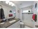 Bright bathroom with granite countertop vanity and a tub with tiled walls at 1010 Tropical Dr, Bradenton, FL 34208