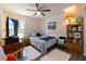 Cozy bedroom features a comfortable bed, bedside table and hardwood floors at 1010 Tropical Dr, Bradenton, FL 34208