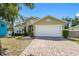 Beautiful single Gathering home featuring a charming exterior with a spacious two-car garage and brick driveway at 1010 Tropical Dr, Bradenton, FL 34208