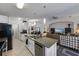 Spacious kitchen with stainless appliances and granite countertops offers view to living room at 1010 Tropical Dr, Bradenton, FL 34208