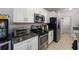 Modern kitchen features stainless steel appliances and granite countertops, and tile flooring at 1010 Tropical Dr, Bradenton, FL 34208