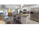 Open kitchen with stainless steel appliances, granite countertops, and a breakfast bar at 1010 Tropical Dr, Bradenton, FL 34208