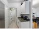 Convenient laundry room with granite countertops, storage cabinets, and stainless steel appliances at 1010 Tropical Dr, Bradenton, FL 34208