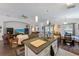 Open floor plan with kitchen island, breakfast table, living room furniture, and hardwood flooring at 1010 Tropical Dr, Bradenton, FL 34208