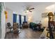 Comfortable living room with ceiling fan, chair, desk, and natural light at 1010 Tropical Dr, Bradenton, FL 34208