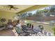 Relaxing screened patio area with ceiling fan and a view of the backyard at 1010 Tropical Dr, Bradenton, FL 34208