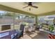 Screened patio with ceiling fan, offering outdoor seating and relaxing space at 1010 Tropical Dr, Bradenton, FL 34208