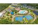 Aerial view of the community pool, tennis courts, playground, clubhouse, ponds, and sidewalks at 1034 Buttercup Gln, Bradenton, FL 34212