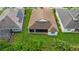 Aerial view of home featuring large yard and screened-in patio at 1034 Buttercup Gln, Bradenton, FL 34212