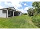 Spacious backyard featuring a screened-in patio and lush green lawn at 1034 Buttercup Gln, Bradenton, FL 34212