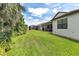 Expansive backyard with lush green lawn and views of the screened-in patio at 1034 Buttercup Gln, Bradenton, FL 34212