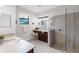 Bathroom vanity with granite countertop, mirrors, a glass shower, and tiled floors at 1034 Buttercup Gln, Bradenton, FL 34212