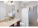 Bathroom featuring granite counters, decorative palm accents, and a fully tiled shower at 1034 Buttercup Gln, Bradenton, FL 34212