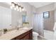 Bathroom with a sink, granite countertops, and shower and tub with curtain at 1034 Buttercup Gln, Bradenton, FL 34212