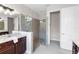 Bathroom featuring double granite vanities, a glass shower, and tiled floors at 1034 Buttercup Gln, Bradenton, FL 34212