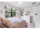 Bright bedroom features large windows offering natural light and verdant outdoor views at 1034 Buttercup Gln, Bradenton, FL 34212