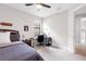 Bedroom with a dark wood bed frame, ceiling fan, dresser, and desk set up at 1034 Buttercup Gln, Bradenton, FL 34212
