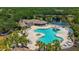 Community pool featuring a water slide, splash pad, hot tub, clubhouse and lush landscaping at 1034 Buttercup Gln, Bradenton, FL 34212