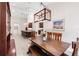 Open-concept dining area featuring a wooden table with chairs and bench seating, adjacent to the kitchen at 1034 Buttercup Gln, Bradenton, FL 34212