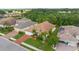 Beautiful single-story home with lush landscaping, brick driveway and mature palm trees, with lawn at 1034 Buttercup Gln, Bradenton, FL 34212